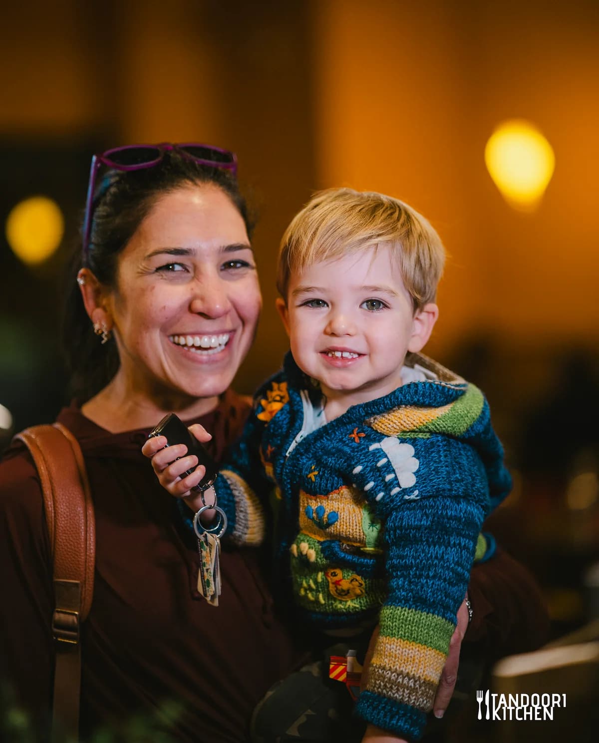 A mom laughing with her son at Tandoori Kitchen